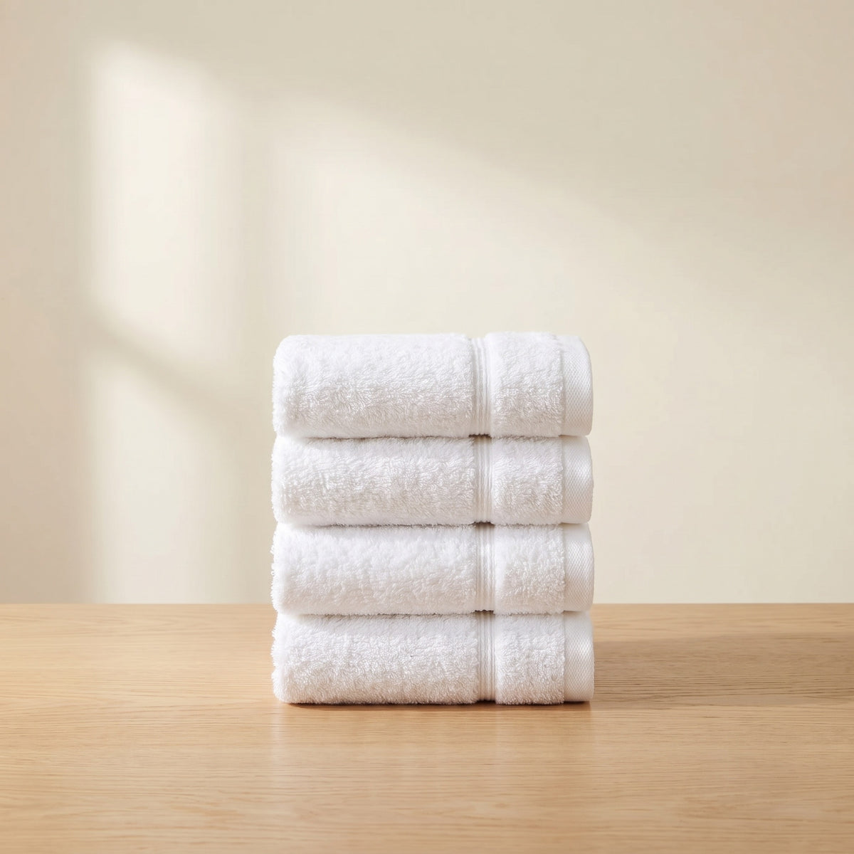 The Skin Set: 4 white Turkish cotton face towels, folded and stacked